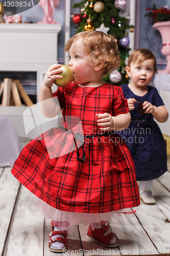 Image of The two little girl standing at studio with christmas decorations