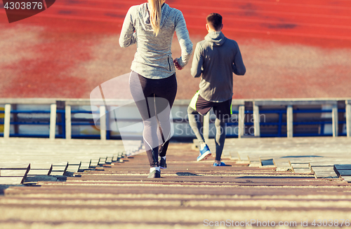 Image of close up of couple running downstairs on stadium