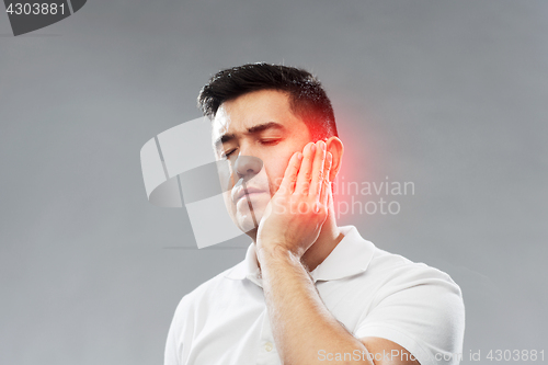 Image of unhappy man suffering toothache