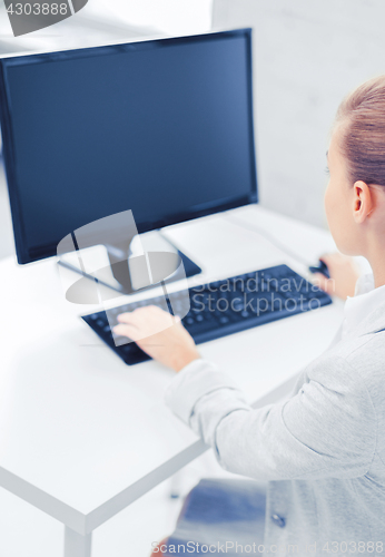 Image of businesswoman with computer in office