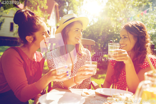 Image of happy women with drinks at summer garden party