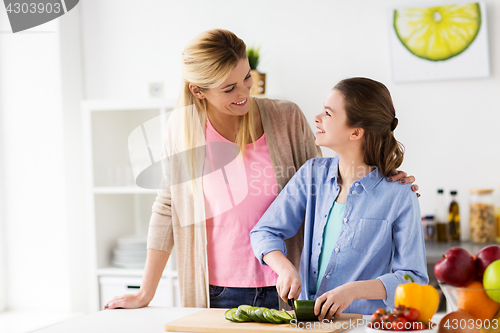 Image of happy family cooking dinner at home kitchen