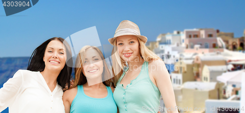 Image of happy women over santorini island background