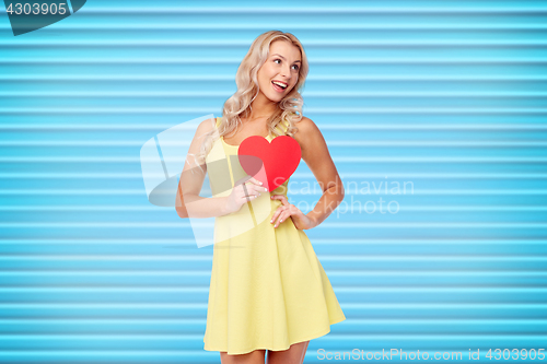 Image of happy young woman with red paper heart