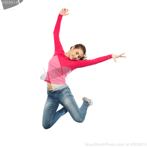 Image of happy young woman jumping in air or dancing