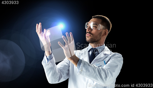 Image of scientist in lab coat and goggles with light