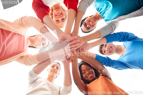 Image of international group of women with hands together