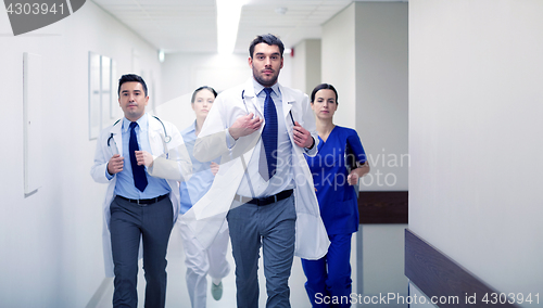 Image of group of medics walking along hospital