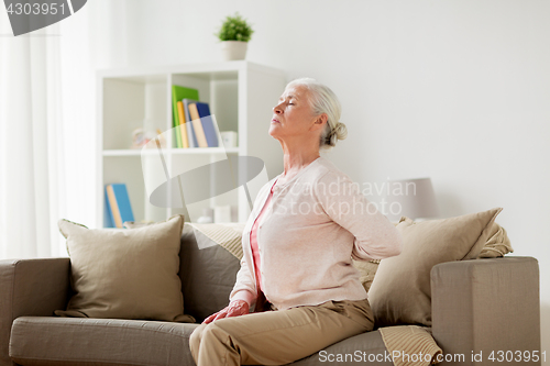 Image of senior woman suffering from pain in back at home