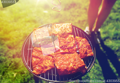 Image of meat cooking on barbecue grill at summer party