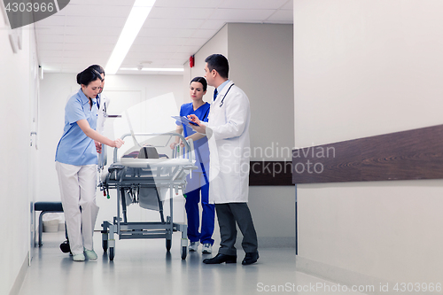 Image of medics with woman on hospital gurney at emergency