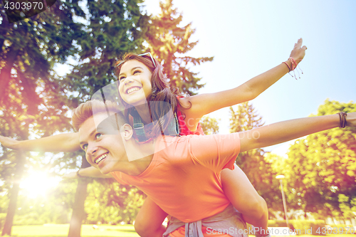 Image of happy teenage couple having fun at summer park