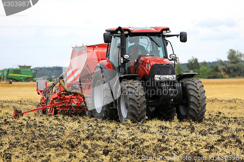 Image of Red Case IH Tractor and Seeder on Field