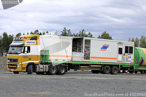 Image of Yellow Volvo FH Semi Hauls Portable Cabin