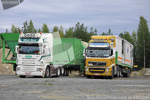 Image of Trucks Deliver Load on Industrial Site