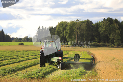 Image of Modern Hay Cutting in Summer Evening