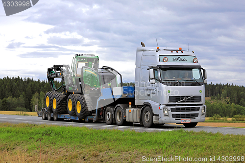 Image of Volvo FH Semi Trailer Transports New John Deere Harvester