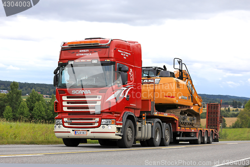 Image of Red Scania R560 Hauls New Case Excavator