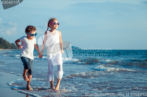 Image of Happy children playing on the beach at the day time. 