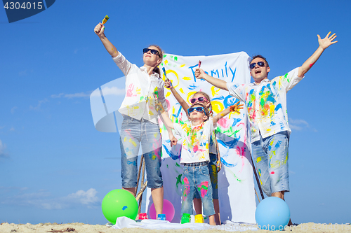 Image of Happy family playing on the beach at the day time.