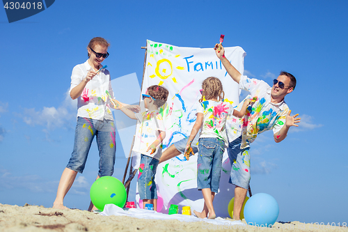 Image of Happy family playing on the beach at the day time.