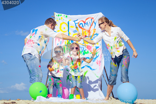 Image of Happy family playing on the beach at the day time.