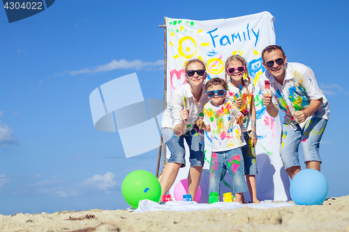 Image of Happy family playing on the beach at the day time.