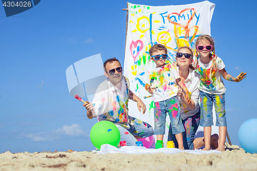 Image of Happy family playing on the beach at the day time.