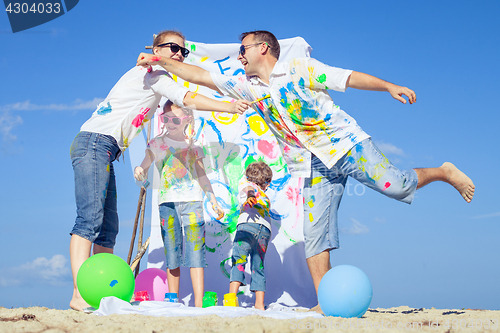 Image of Happy family playing on the beach at the day time.