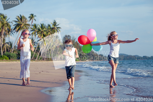 Image of Happy children playing on the beach at the day time.