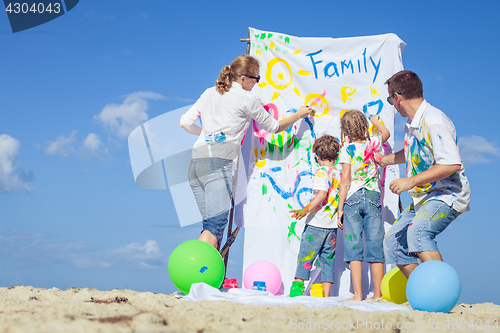 Image of Happy family playing on the beach at the day time.