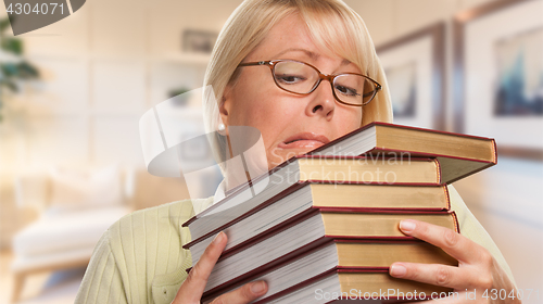 Image of Beautiful Expressive Student or Businesswoman with Books in Offi