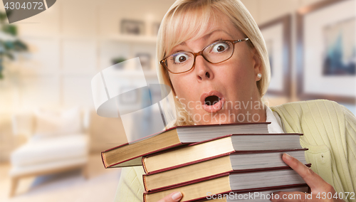 Image of Beautiful Expressive Student or Businesswoman with Books in Offi