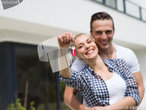 Image of couple hugging in front of  new luxury home