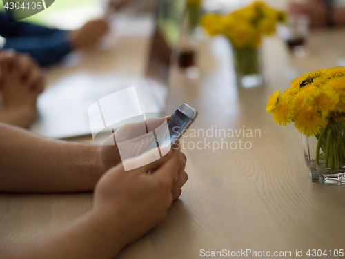 Image of Young man holding smartphone