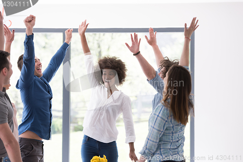 Image of multiethnic startup Group of young business people celebrating s