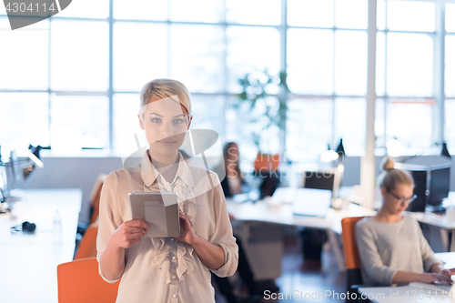 Image of woman working on digital tablet in night office