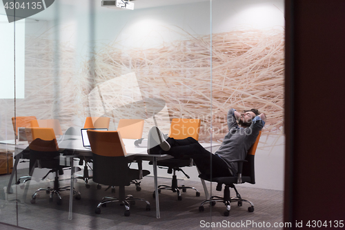 Image of businessman relaxing at the desk