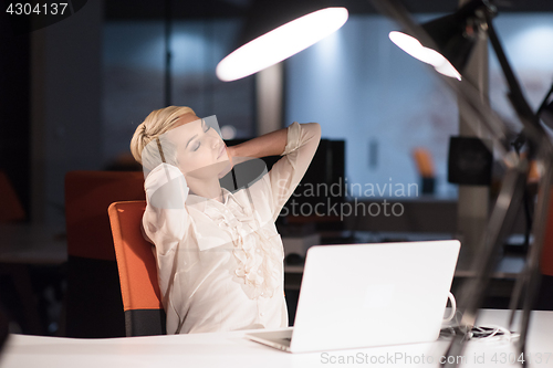 Image of woman working on laptop in night startup office