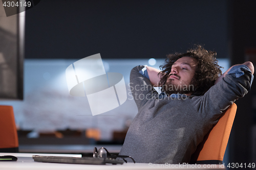 Image of businessman relaxing at the desk