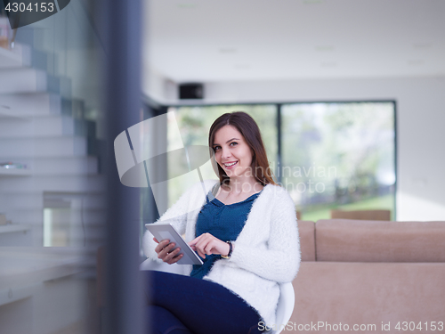 Image of young women using tablet computer by the window