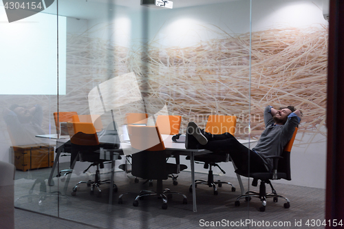 Image of businessman relaxing at the desk