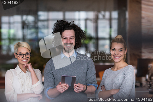 Image of group of Business People Working With Tablet in startup office