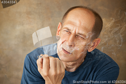 Image of Worried mature man sitting at studio