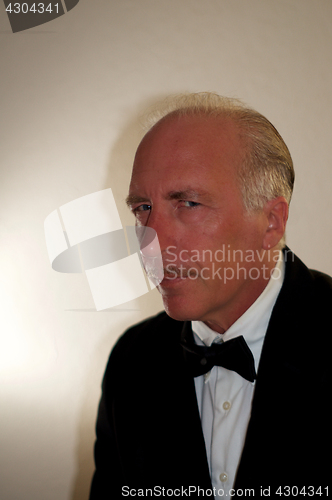 Image of portrait of professional mature man in tuxedo