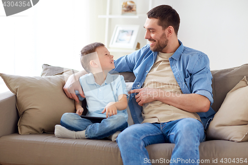 Image of father and son with tablet pc at home