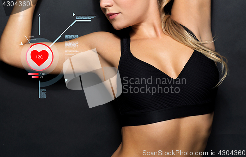 Image of close up of woman in black sportswear with pulse