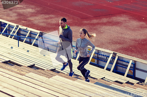 Image of couple running upstairs on stadium