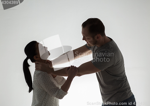 Image of couple having fight and man choking woman