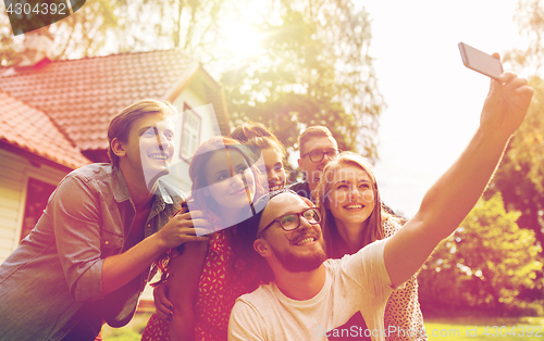 Image of friends taking selfie at party in summer garden